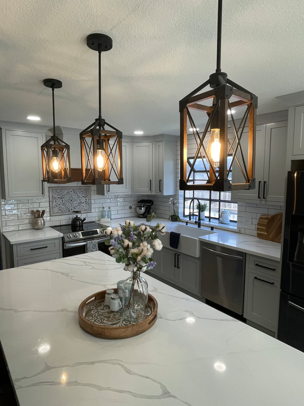 Remodeled kitchen with island and pendant lighting
