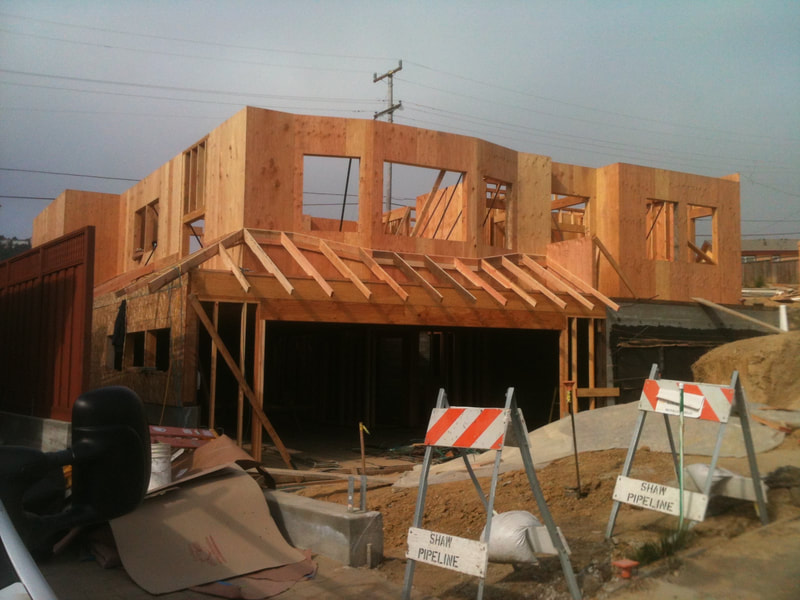 DLM Builders Instagram post — home framing at dusk