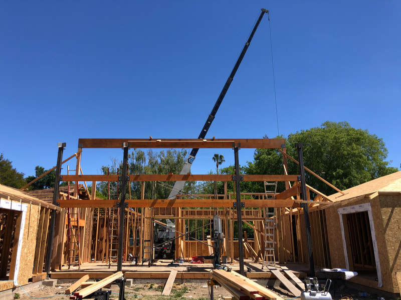 DLM Builders Instagram post — crane setting structural beams