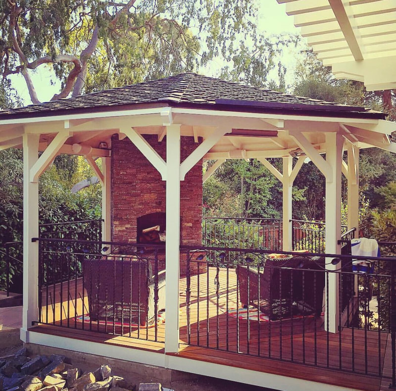 Custom outdoor gazebo with stone fireplace